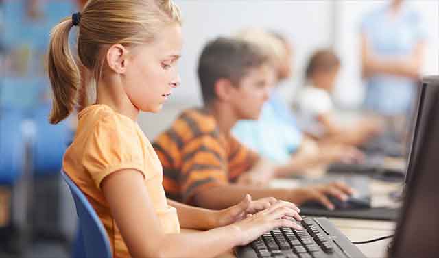 School age children using lapotops to complete testing